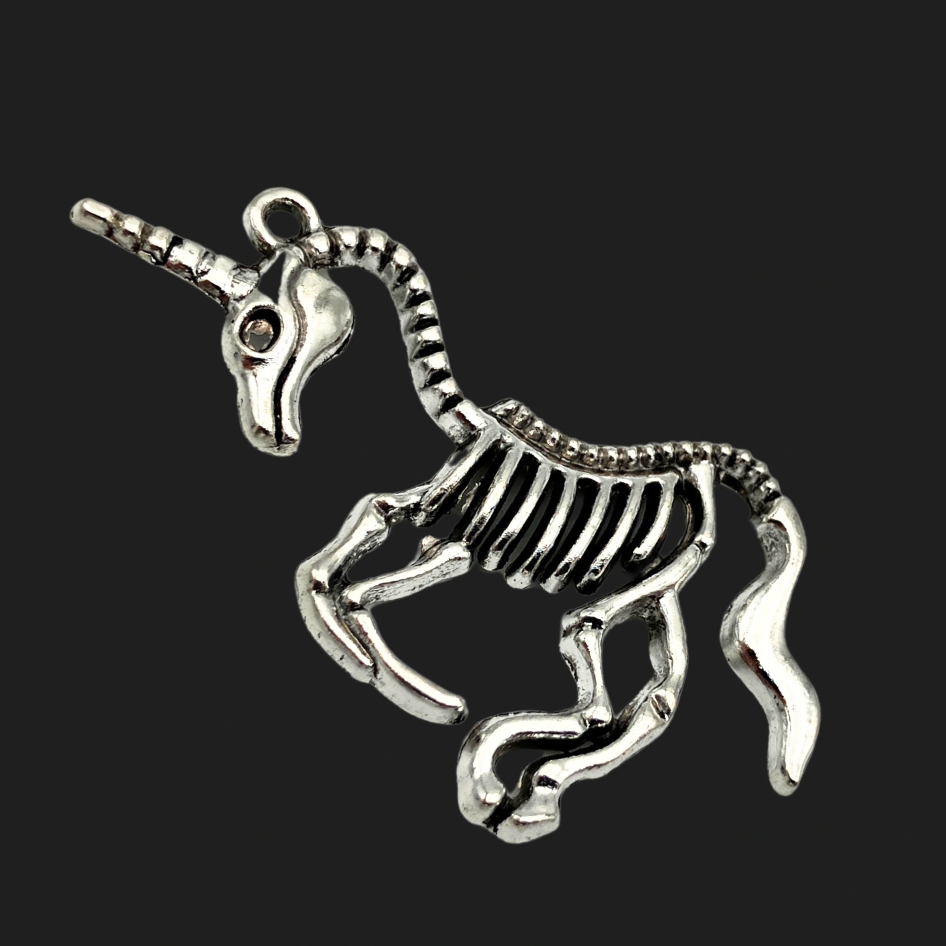Unicorn skeleton pendant with ribcage body and horn – gothic fantasy charm