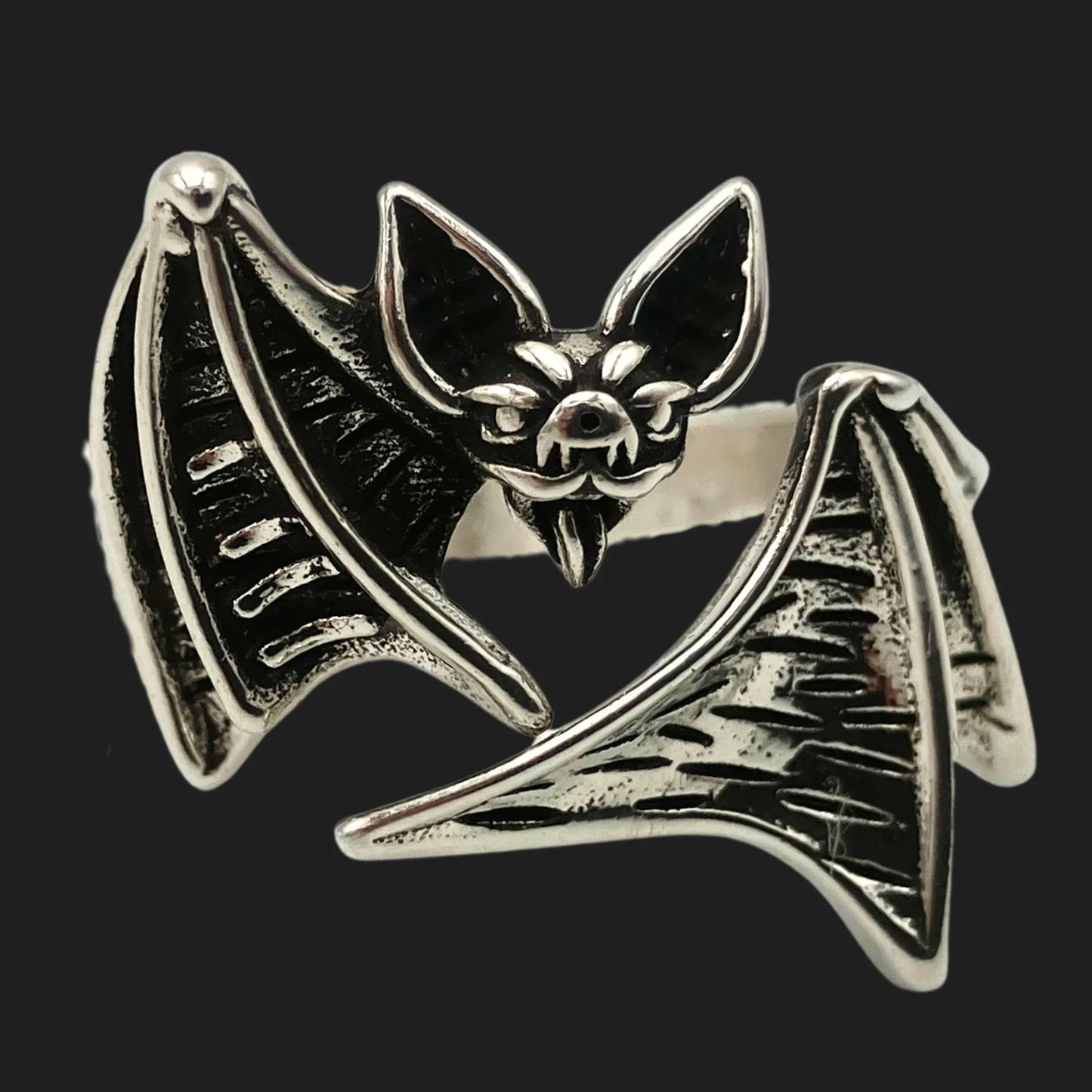 Gothic vampire bat ring with fanged face and spread wings in silver-tone alloy