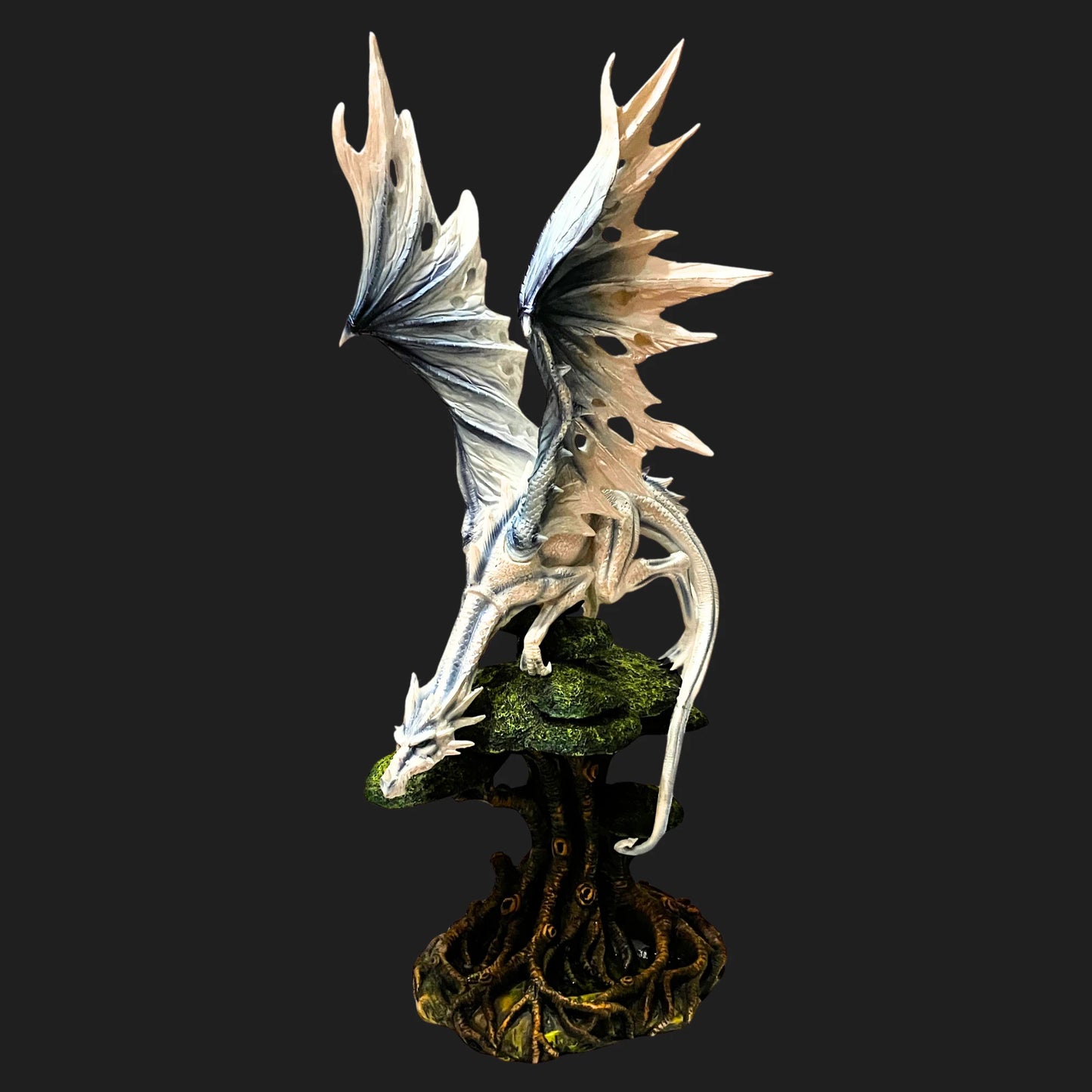 Angled view of 21.5-inch White Dragon perched on forest roots, shimmering in icy tones.