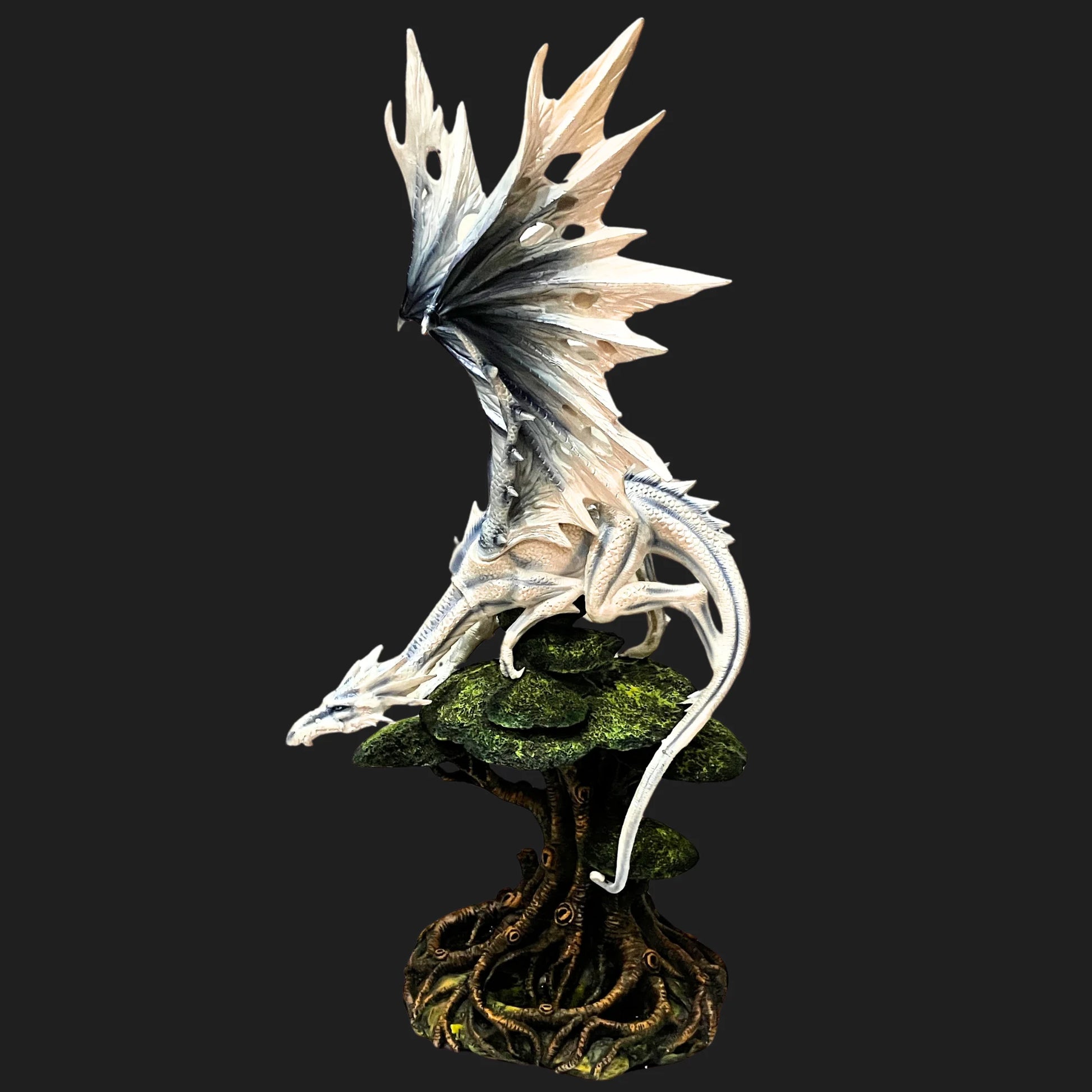 Side view of Frostbound Sentinel White Dragon figurine, showing silver scales and elegant posture.