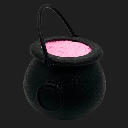 Black witch cauldron bath bomb filled with bright pink fizzing powder