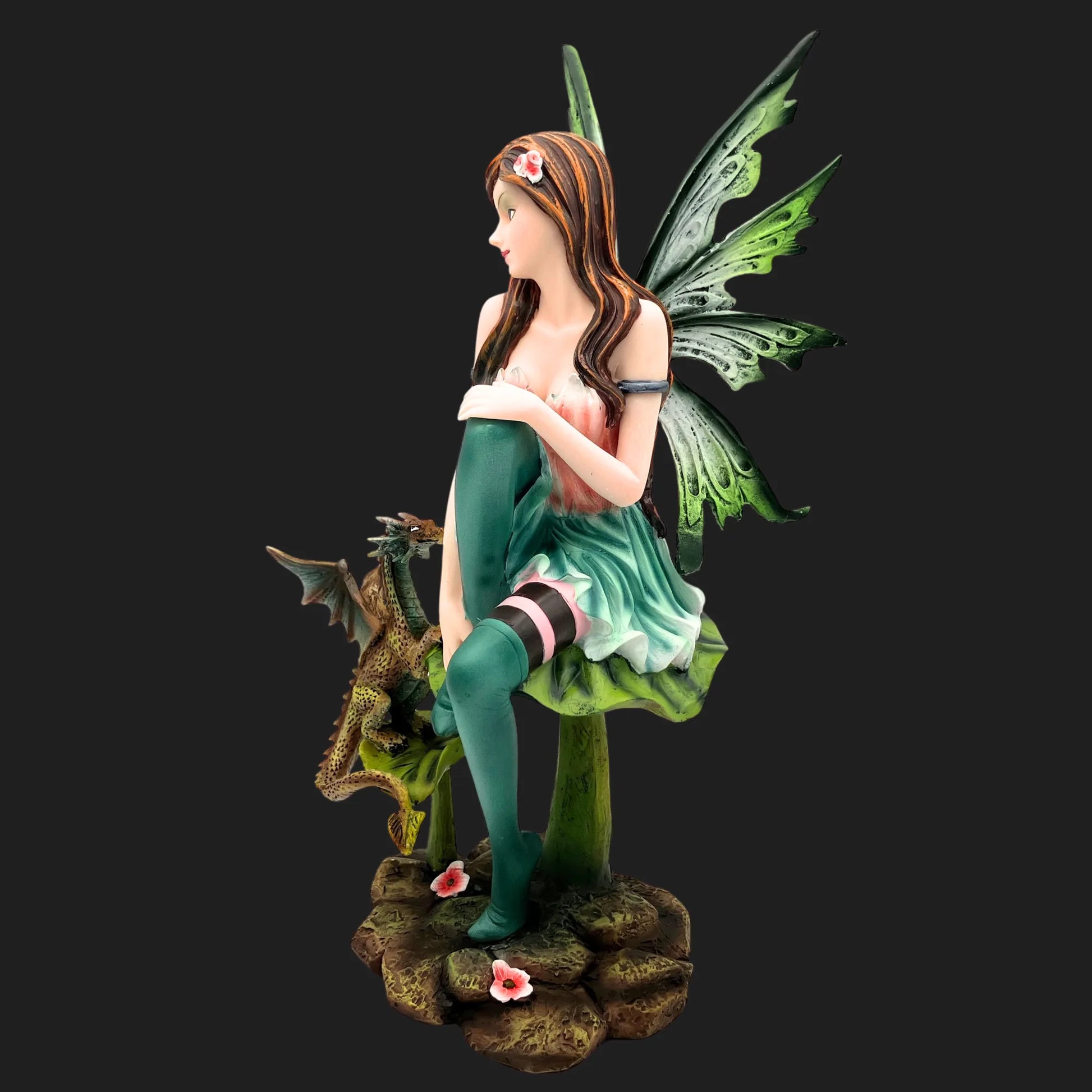 Detailed woodland fairy figurine in green dress with dragon companion on base with flowers.