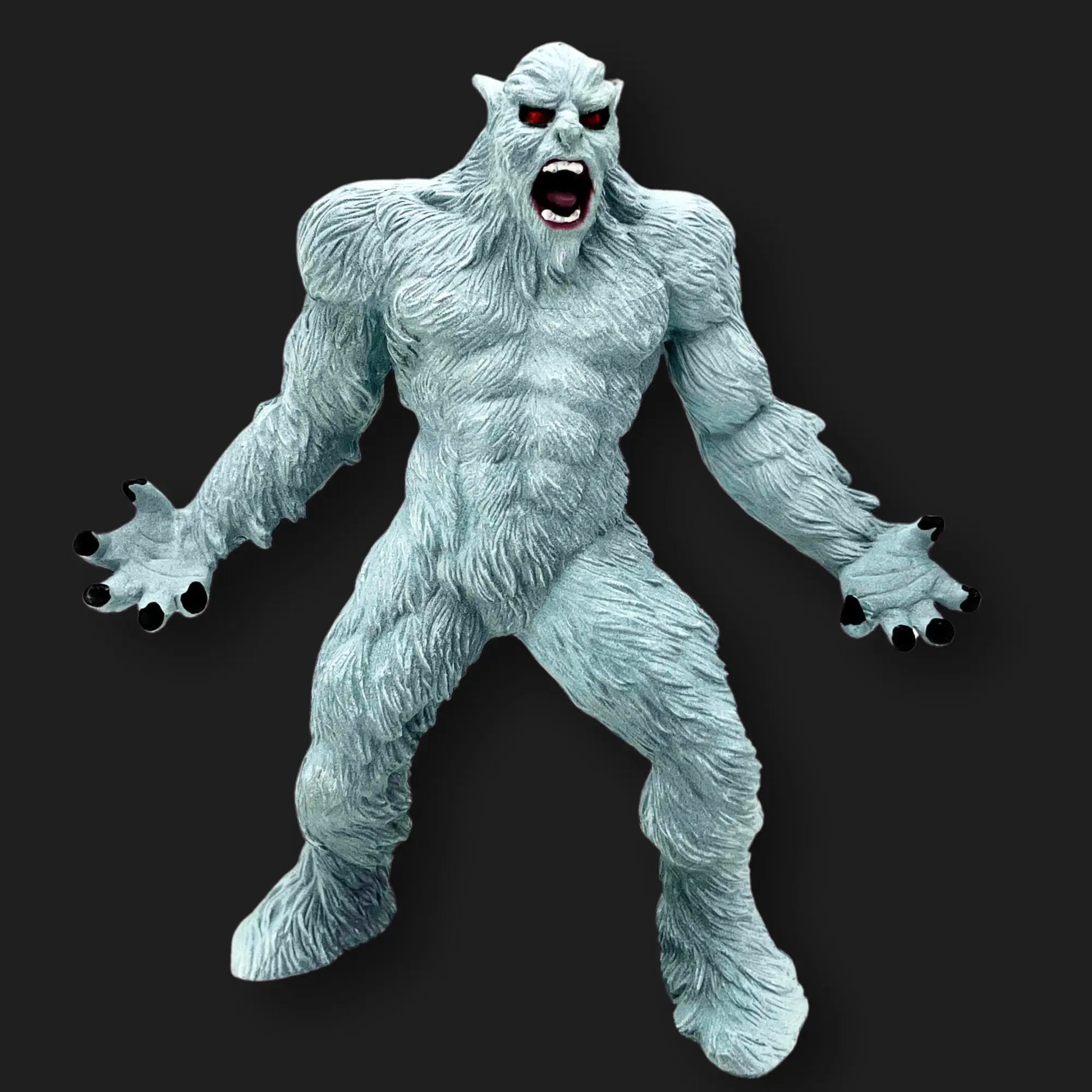 White Yeti figurine with red eyes, open mouth, and claws extended, front angle.