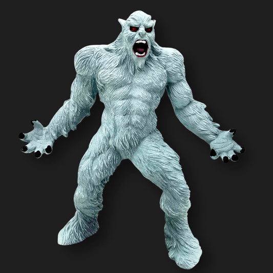 White Yeti figurine with red eyes, open mouth, and claws extended, front angle.