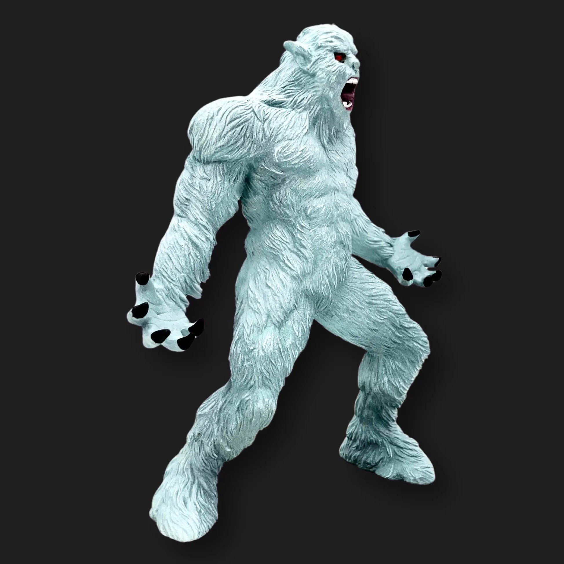 White Yeti figurine side view, muscular build with sharp claws and fierce expression.